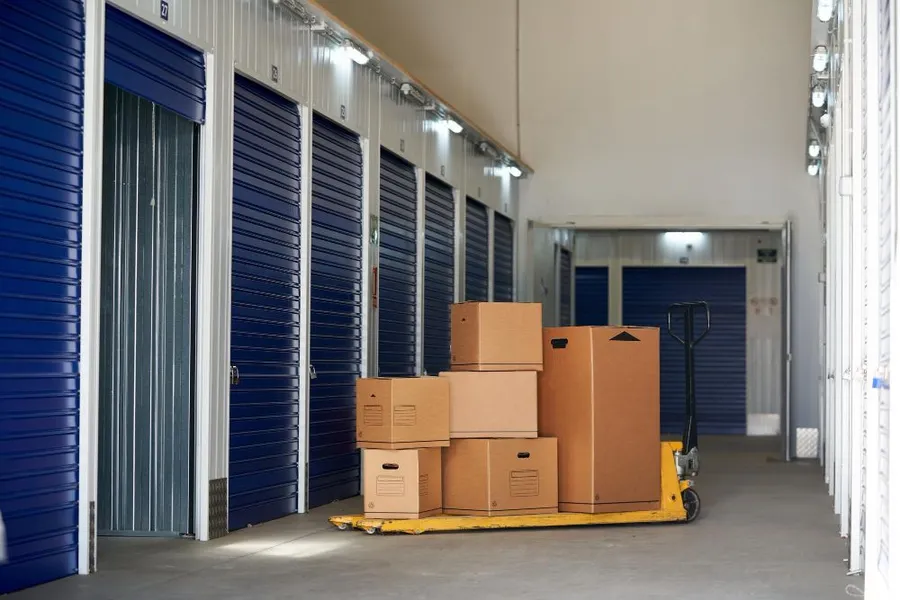Boxes stacked on a dolly inside a storage facility