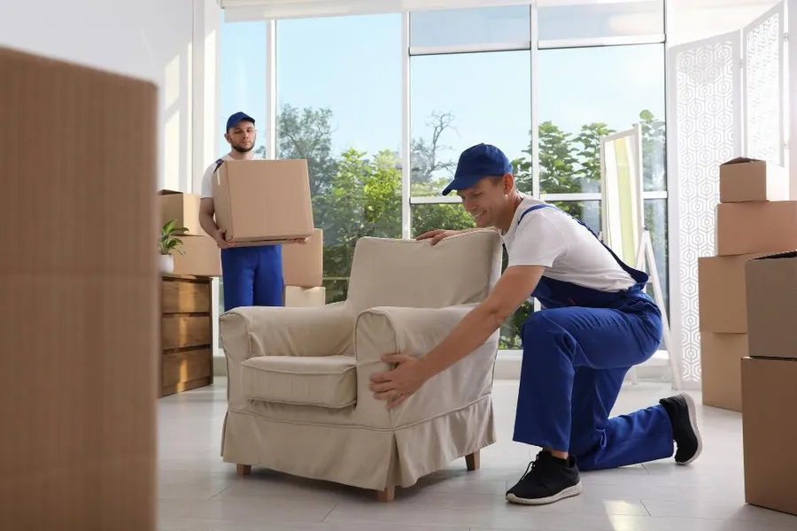 Bulldog Moving crew moving an armchair in Charlotte