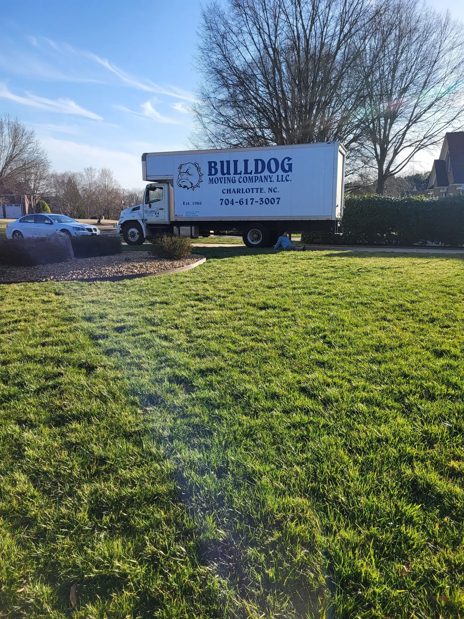 Bulldog Moving truck parked by a customer's front lawn