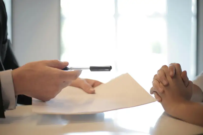 Customer reviewing and signing a moving contract during a consultation