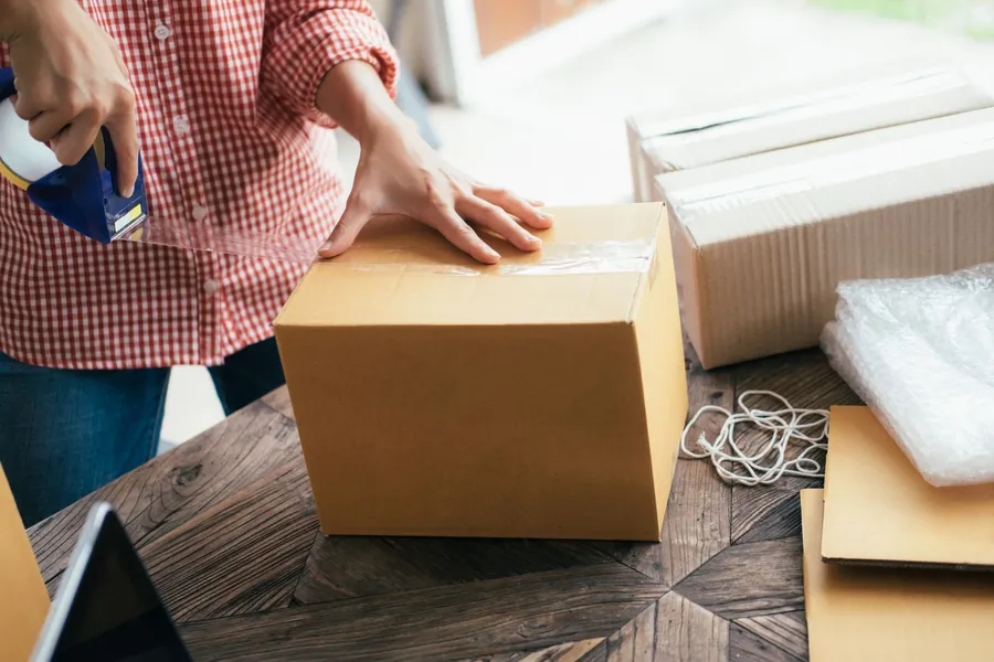 Movers packing office boxes on a flexible schedule